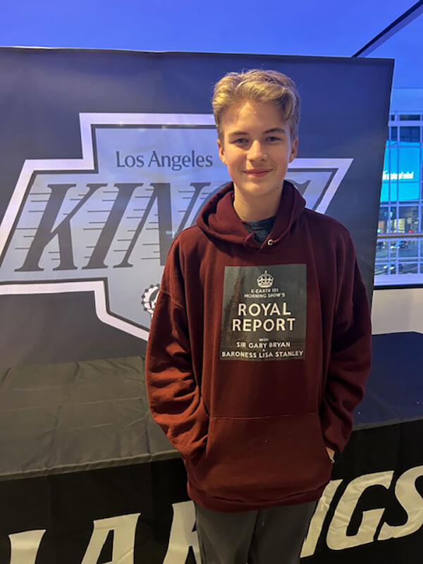 Fan of the Month Cooper Richards wearing a maroon hoodie with the Royal Report logo in the middle.